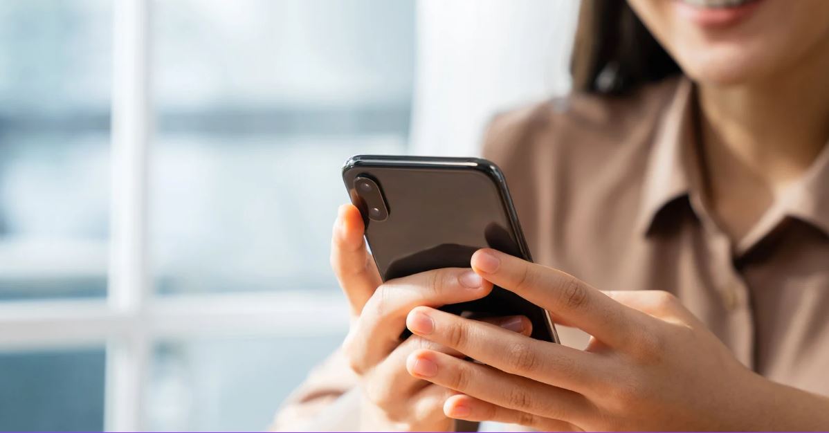 Woman checking social media on cellphone